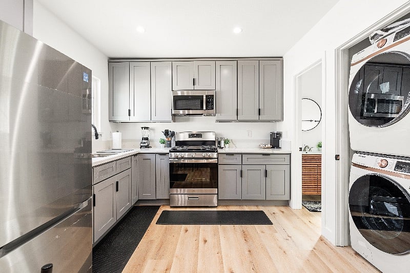 Brand new stainless steel appliances (No dishwasher) with a brand new smart stackable washer/dryer.