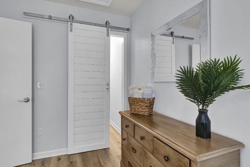 Small walk in closet with plenty of room for hanging clothes. 