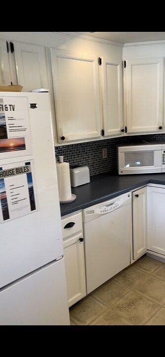 Full refrigerator, dish washer, and microwave. Cabinets are full of all the dishes, pots, and pans you'll need.