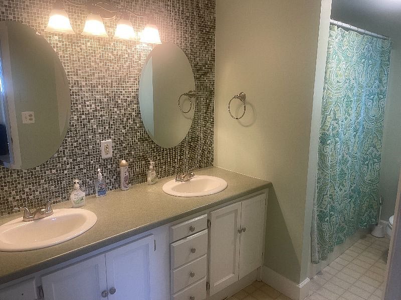 1st floor bathroom complete with double sinks and full tub / shower.