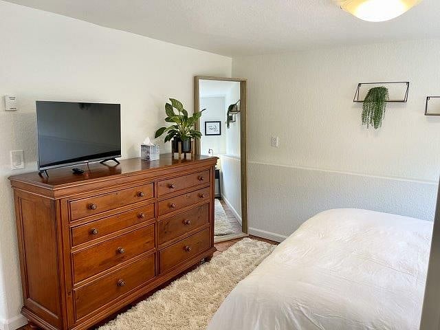 Bedroom with Roku TV and full size mirror