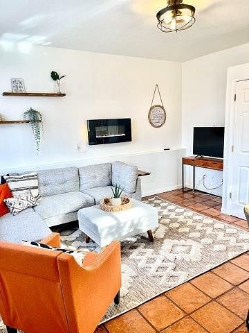 Living room with sectional comfortable seating and wall mounted Roku TV
