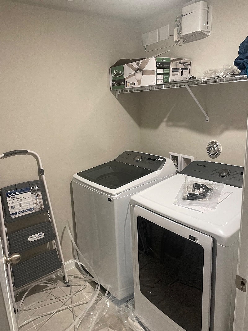Large laundry room with brand new washer and dryer and vacuum cleaner 