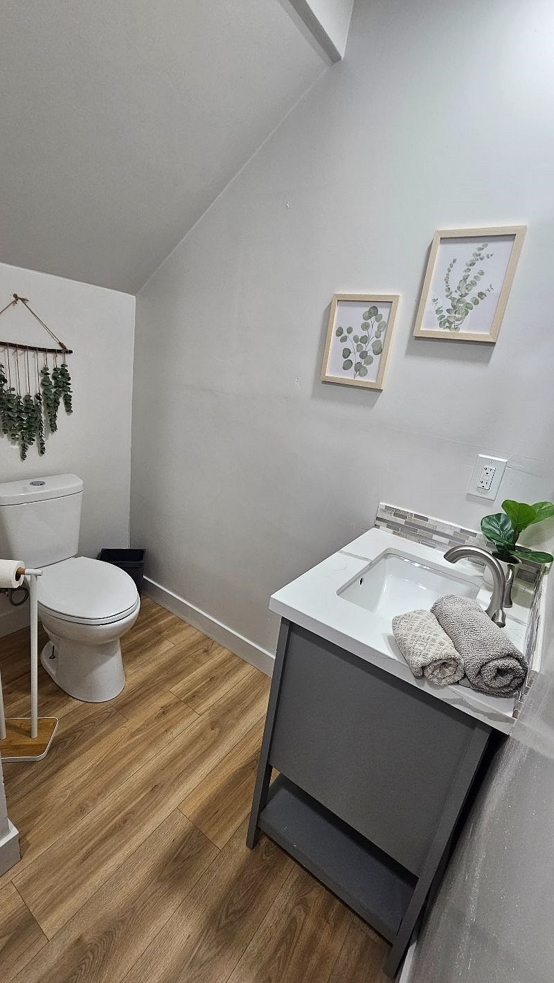 Powder room downstairs by the coffee bar. This is also where the stacked full size washer/dryer are located.