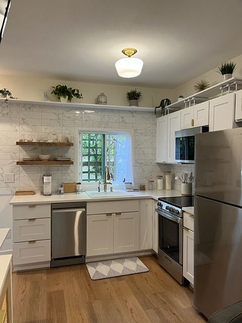 Large, open kitchen with new cabinets, stainless steel appliances, sink, garbage disposal, lazy susan corner cabinet.