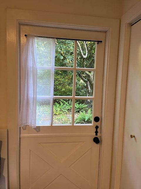 Charming Dutch door provides lovely garden views.