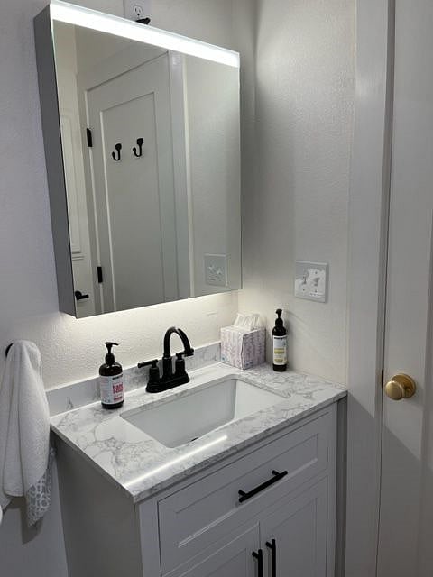 Large, lighted, LED, mirrored medicine cabinet provides additional storage.
