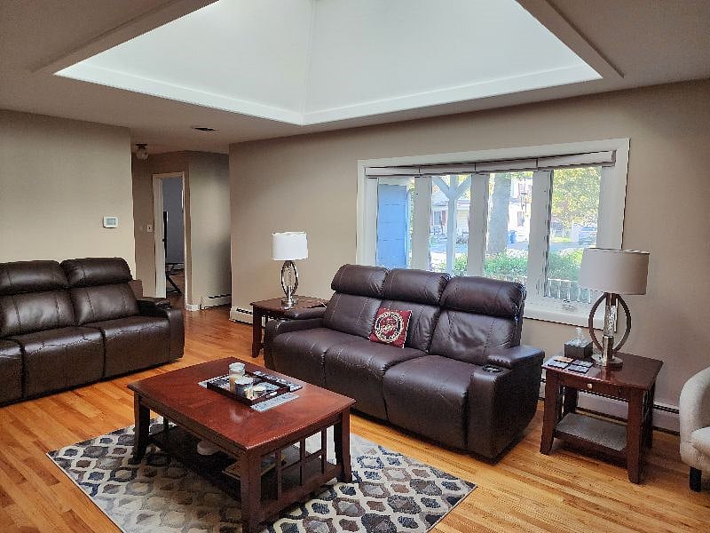 Living room area with automatic solar skylights and TV. Watch a movie or your favorite series! I have wireless headphones so you don't have to hear the TV while I watch or you can watch without bothering anyone.