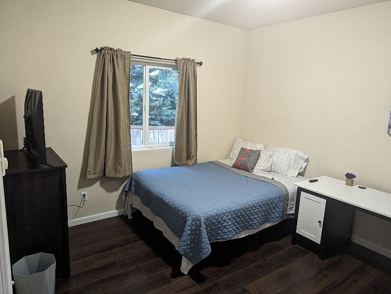 Guest Room 1 with queen bed; Smart TV included.