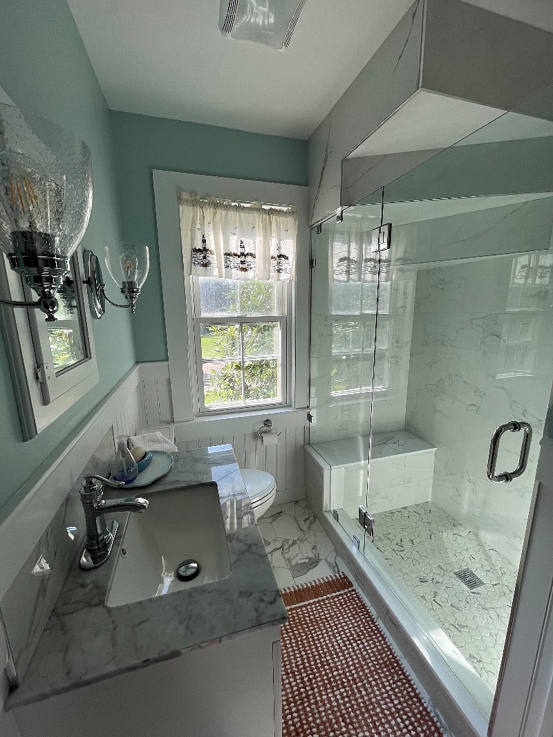 Just renovated bathroom with spacious shower with built in bench.