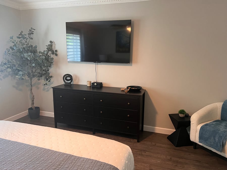 Guest room with dresser and smart TV
