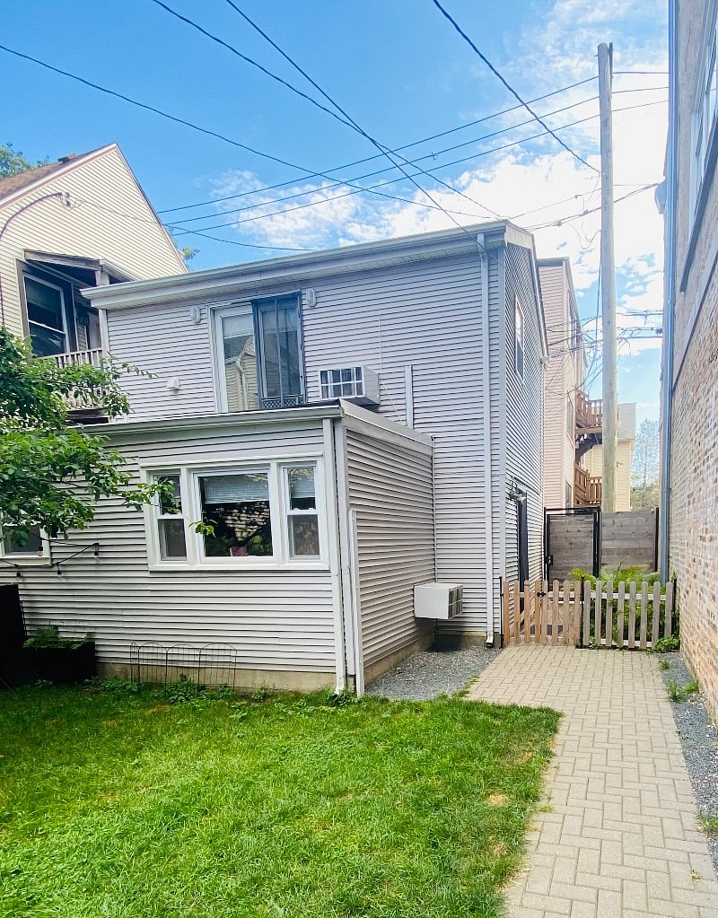 Exterior with private back gate (through alley) and small private gate (there is a dog on site)