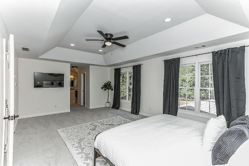 Bedroom has a 50 inch TV and attached bathroom