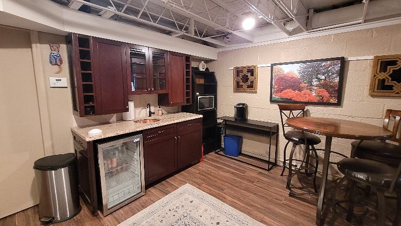 Kitchenette with fridge, microwave, coffee maker and small dinette. Basic kitchen supplies provided.