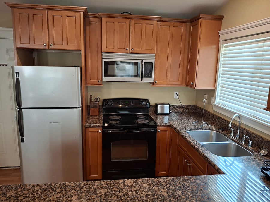 Full kitchen stocked with pots and pans and cooking utensils.