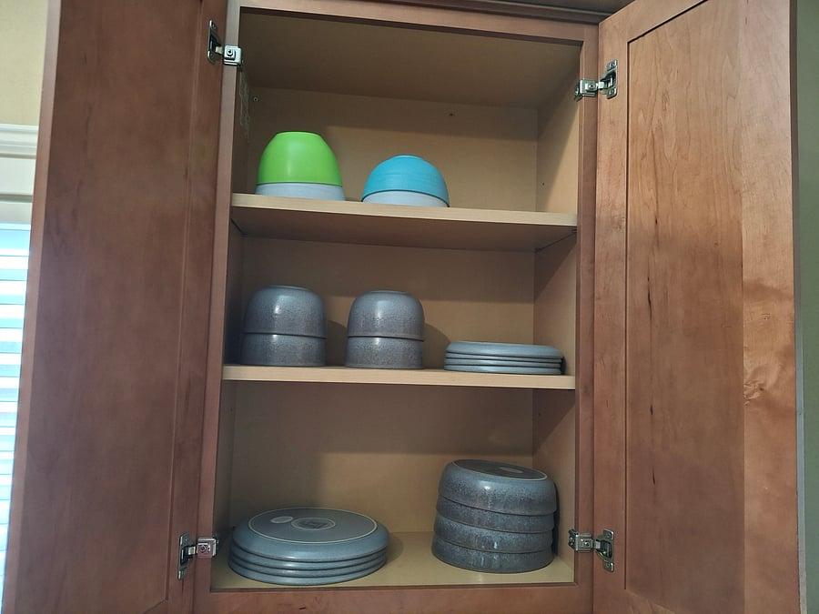 Brand-new stoneware bowls and plates, including cups and mugs for drinking.