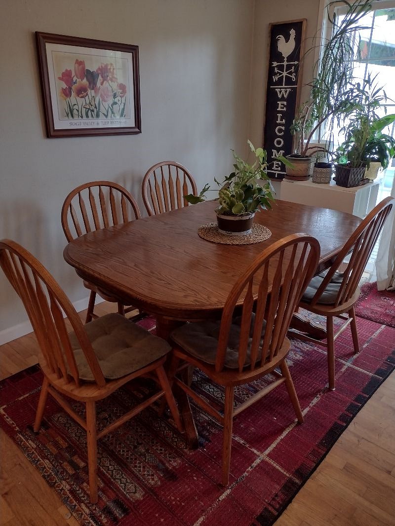 Shared dining area with oak table and chairs. Slider to deck. 