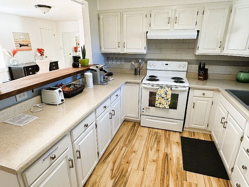 Full Kitchen with cooking ware, utensils, plates, cups, coffee maker, automatic kettle, and toaster. 