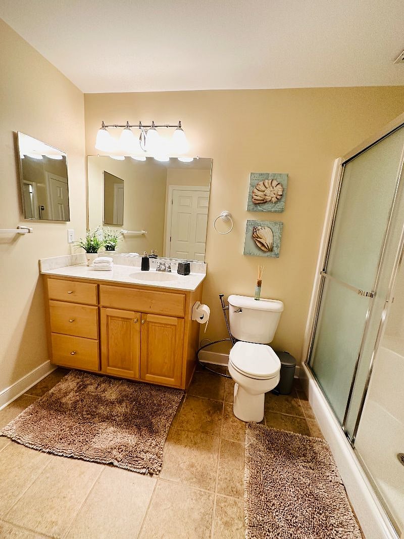 Private full bathroom with spacious drawers, plush white towels, and linen closet.
