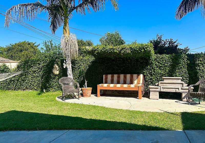 Serene backyard, featuring lush greenery & vibrant flowers that create a tranquil atmosphere.