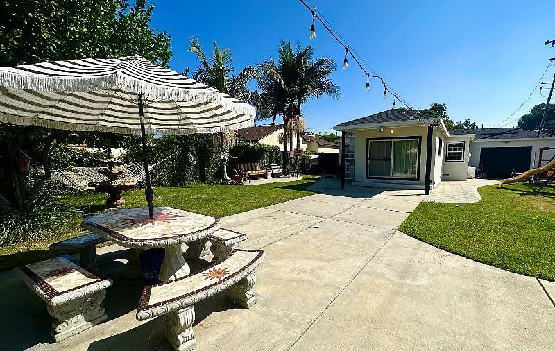 View of the yard looking back towards your room. The backyard is a peaceful oasis where you can unwind, relax, and enjoy the beauty of nature. It's perfect for morning coffee, reading a book, or simply taking in the fresh air.