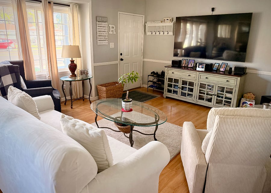 Shared living room area has in home theater system and comfortable lazy-boy couches