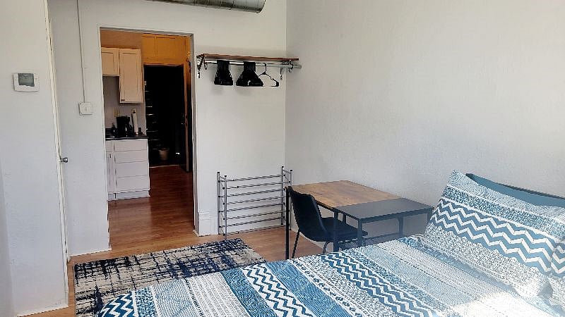 Side of the bed with dedicated workspace and storage where you can hang your shirts, etc!