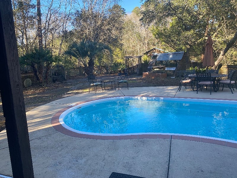Pool and backyard with private dock