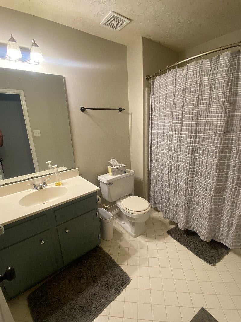 Private bathroom located a few steps down hallway