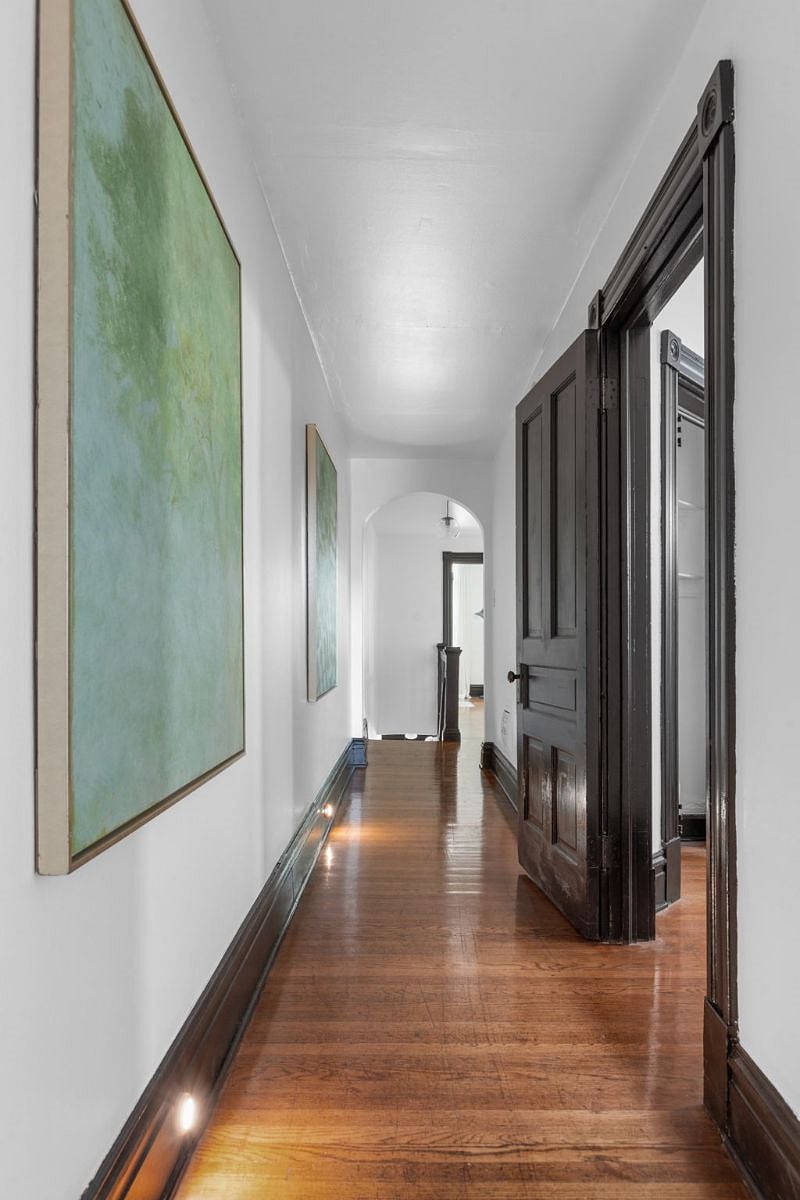 Hallway - view from back door to building basement. The door on right is for the queen bedroom - it opens into the hallway :) The study and the front staircase are past the arch at the other end of the hallway