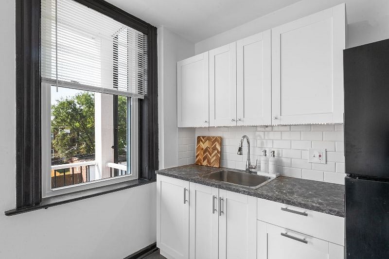 Kitchen - view of brand new cabinets, laminate countertop, sink and backsplash.
