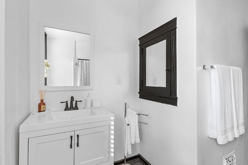 Bathroom - view of vanity, sink and original medicine cabinet.