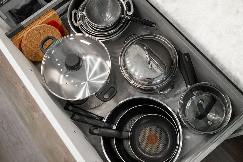 Pull out kitchen drawers with Pots & Pans, skillets, mixing bowls, and hot pad trivets.