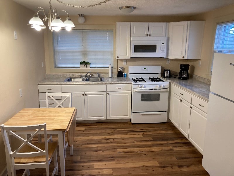 Full kitchen has plenty of space and storage. Gas stove and full sized fridge.