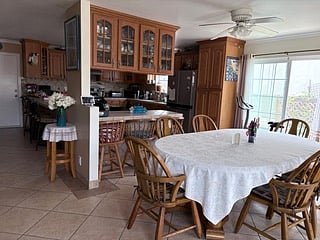 open formal dining, bar seating and kitchen in the back