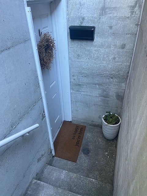 10 step entry with sturdy railing to enter. Motion sensor light above the door that will activate dusk to dawn. Electronic keypad entry to unit. Mailbox provided outside door.