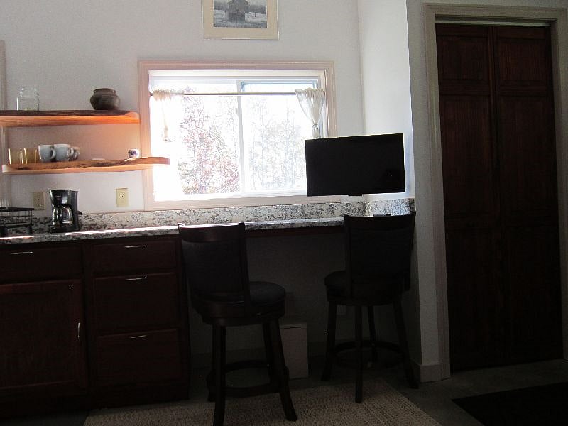 TV extends for viewing while on the couch, or up against wall for viewing while cooking or sitting at counter