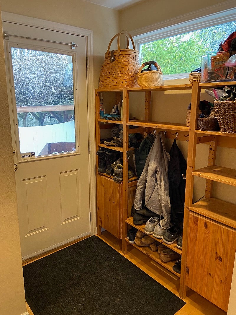 Side door entry, with shoe and coat rack to share. It's off the kitchen