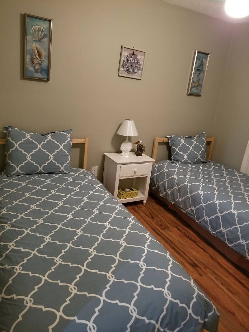 1st bedroom- ceiling fan, closet, dresser, mirror