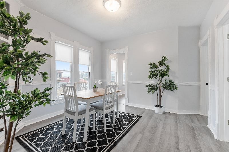 Spacious dining room with fantastic views of the city and 1910 architecture with arches, tall windows, and a built-in corner hutch