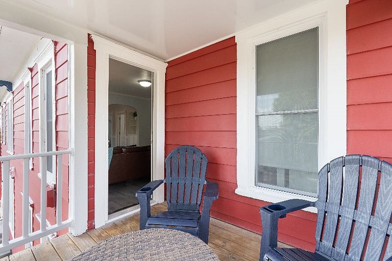 Private balcony with two Adirondack chairs and a coffee table.