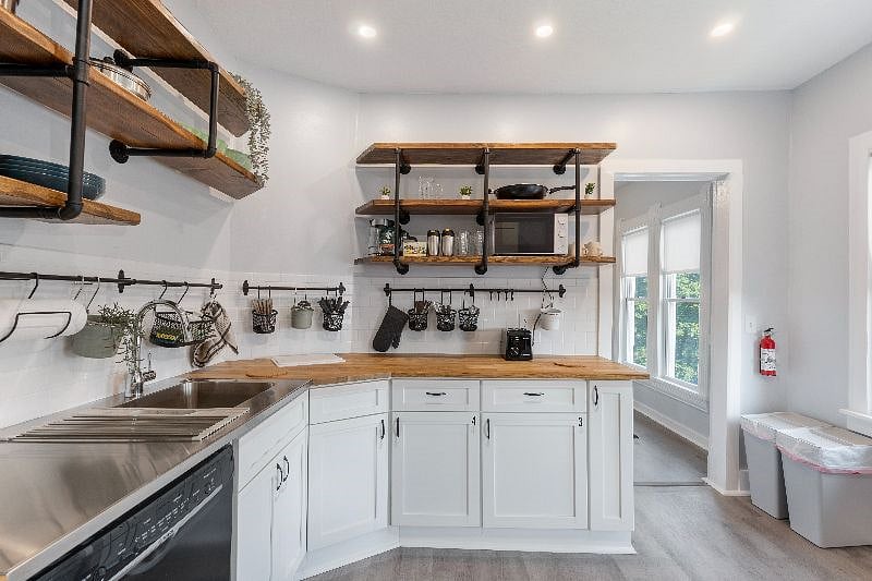 The kitchen has a dishwasher, microwave, electric stove, refrigerator, garbage disposal, electric kettle, and coffee maker.