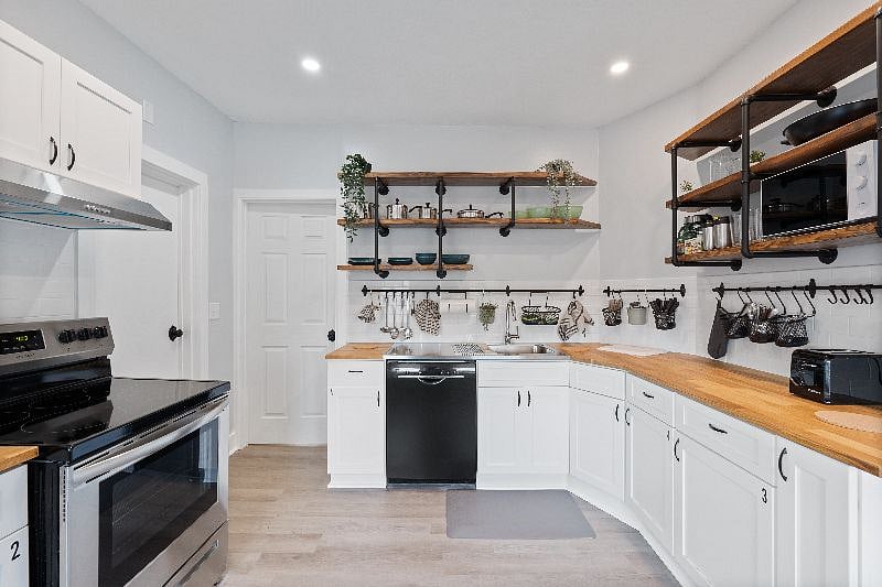 The kitchen has dishware and cookware.