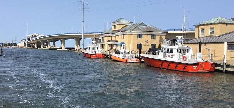 Virginia Pilot Association launch boats at the East foot of the bridge. Their mission is to deliver Ship Pilots to the various freighters and Naval vessels entering the Bay and Hampton Roads waterways heading to various Piers and Terminals. The Pilot goes aboard and takes over command of the ship to safely  pilot the ship through the shifting shoals of the Bay and Rivers to their destination.