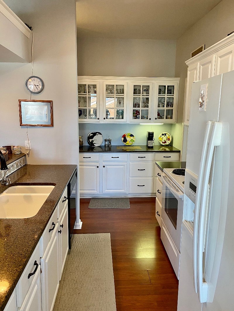 Convenient walk-through Kitchen with every appliance you want or need. Super efficient layout too. Nice upgraded granite counters with white porcelain sink and new gooseneck faucet. Beautiful glass cabinet doors.