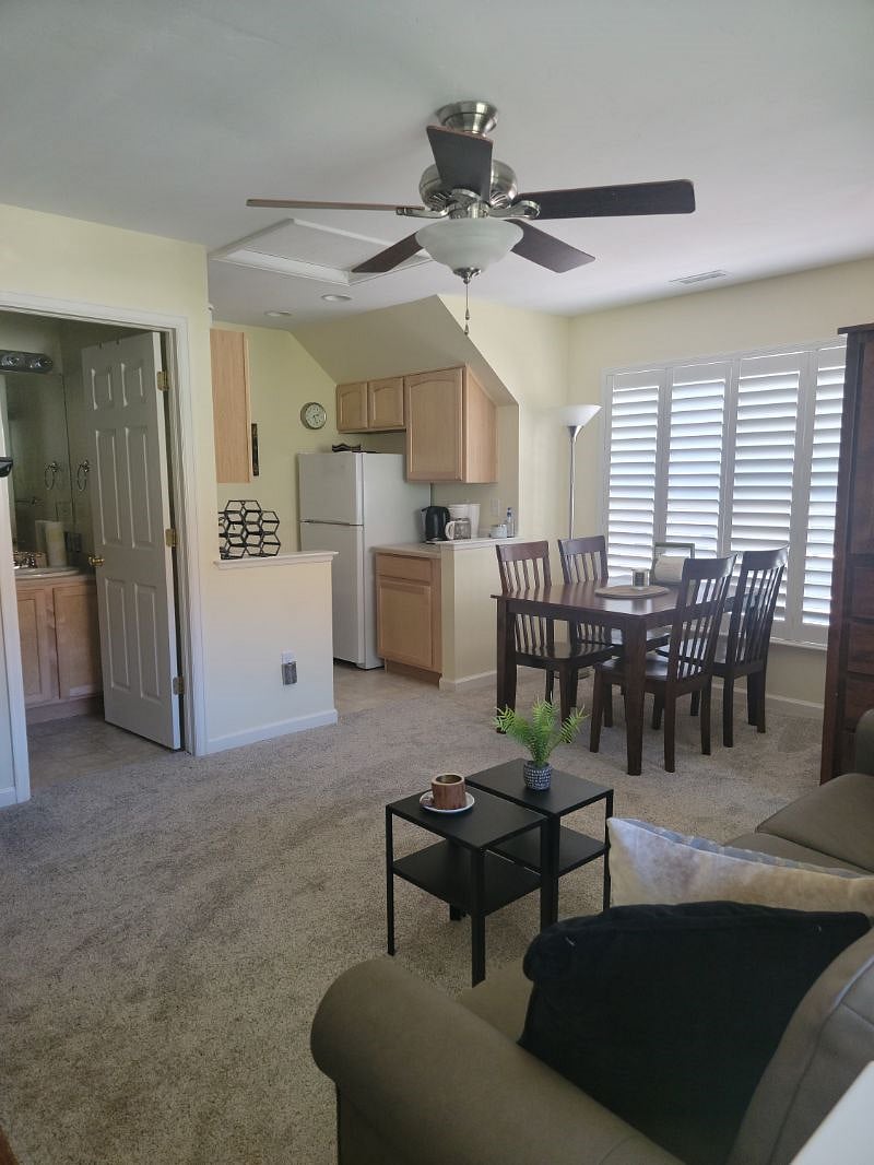View of apartment including queen sofabed, dining area, kitchen and bathroom.