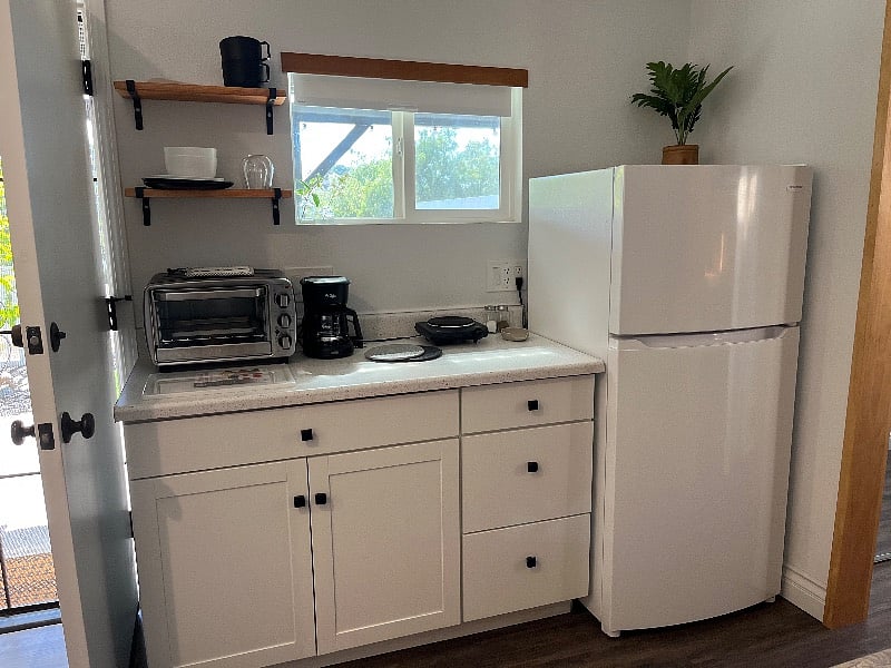 Fully functional kitchenette with large toaster oven, single burner, coffee maker, clean fridge & freezer and lots of storage