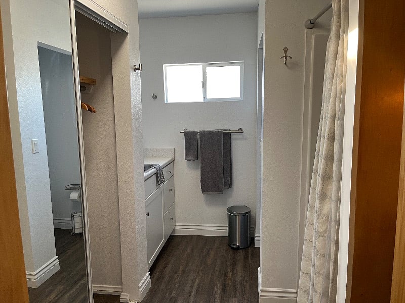Spacious bathroom with shower, soft towels and large closet w/ hangers and luggage racks