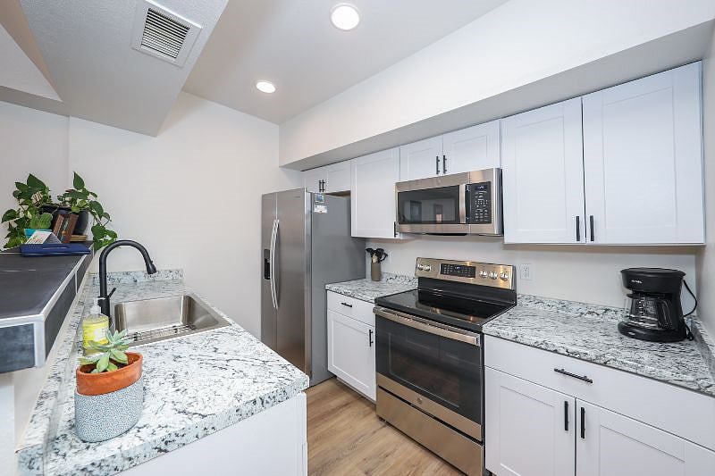 New appliances in well-appointed kitchen, dishwasher across from fridge