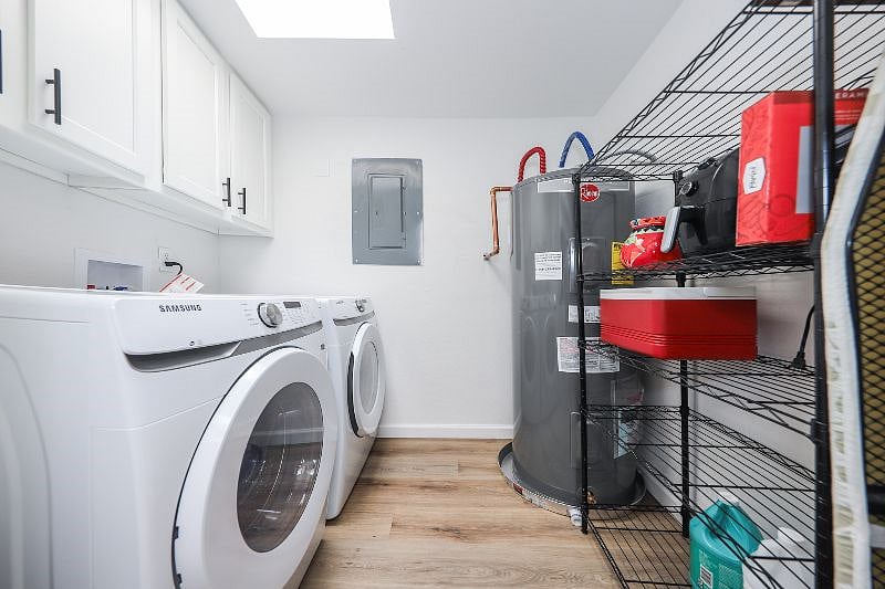 laundry room off of kitchen with new washing machine and dryer; storage